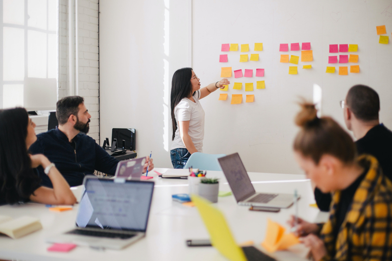 Team whiteboard session with colourful sticky notes